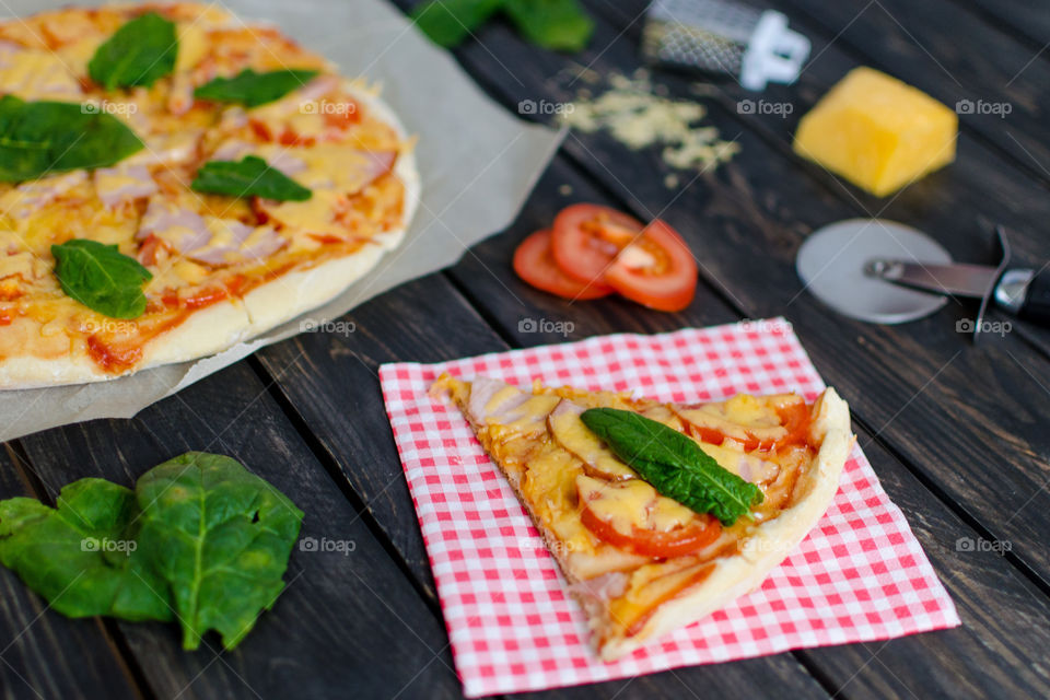 Pizza with cheese, salami and tomatoes