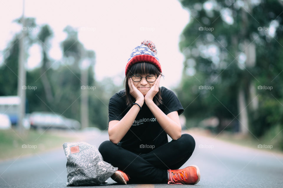 Cute girl sitting on the road