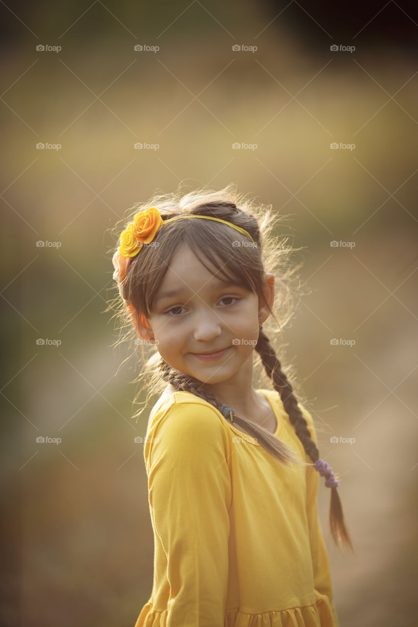 Little girl in yellow dress outdoor portrait 