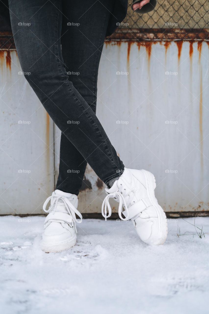 Young woman in white Dr. Martens boots in winter 