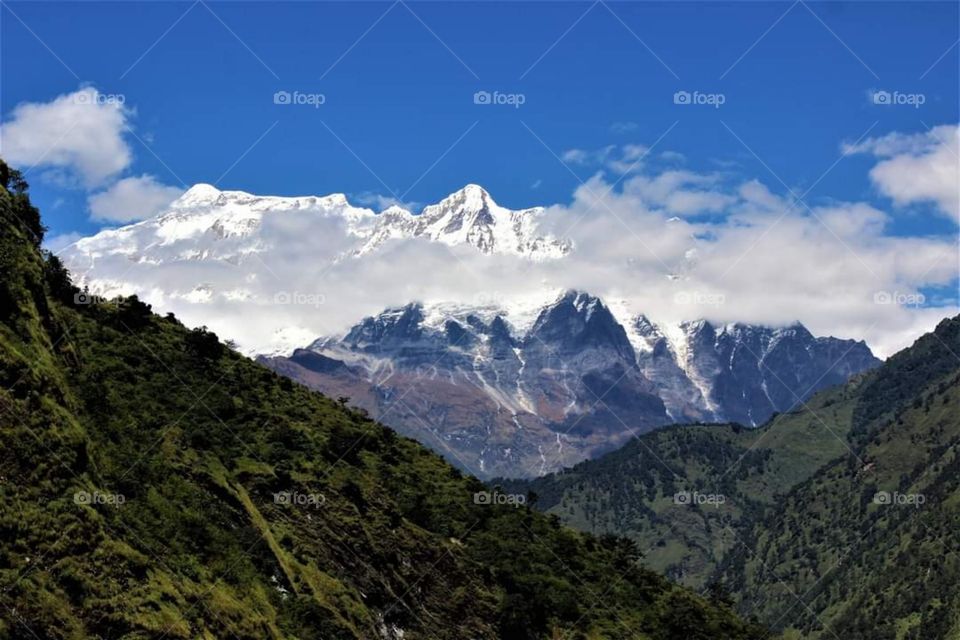 The snowy peaks of the Dhaulagiri Range begin to emerge as we continue trekking up. Photo taken on the Dhaulagiri Circuit Trek in Nepal.