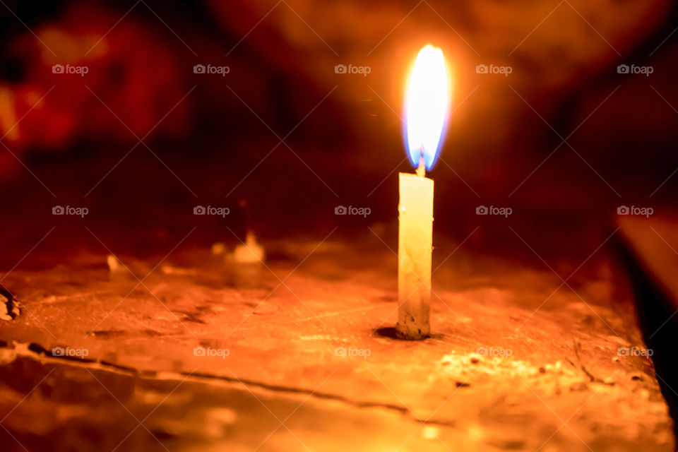 A christmas candle spreading light on black background in Diwali festival, a traditional celebration of India.