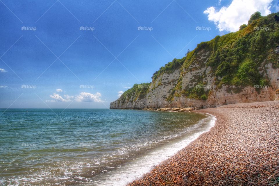 A pebble beach in Devon, UK on a beautiful summer day. 