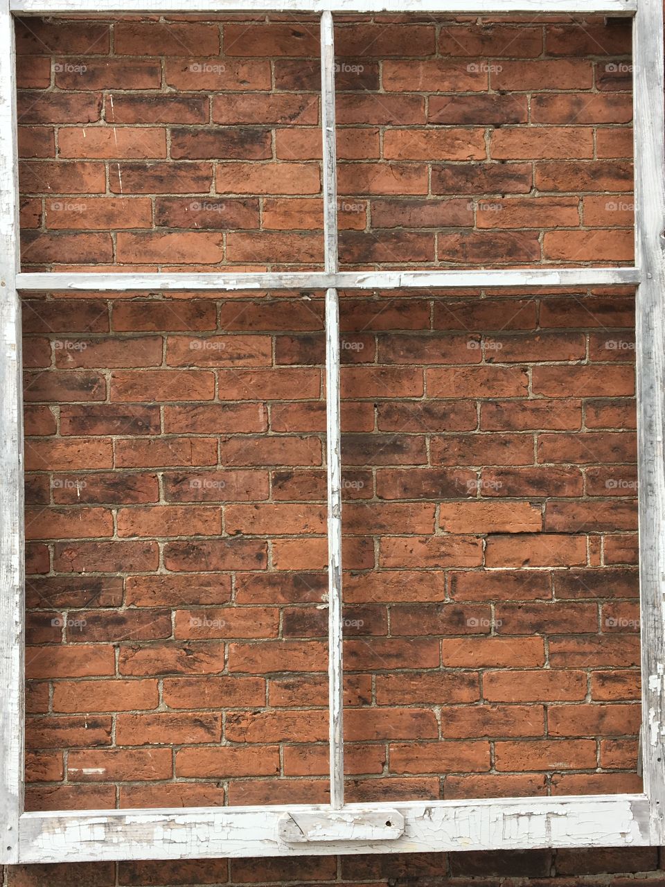 Large wooden frame against vintage brick wall
