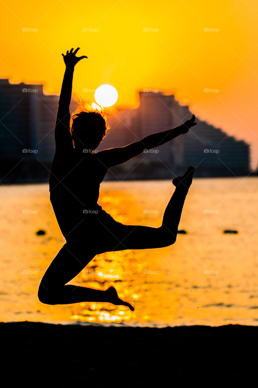 Jumpin on the beach of Abu Dhabi during golden hour.