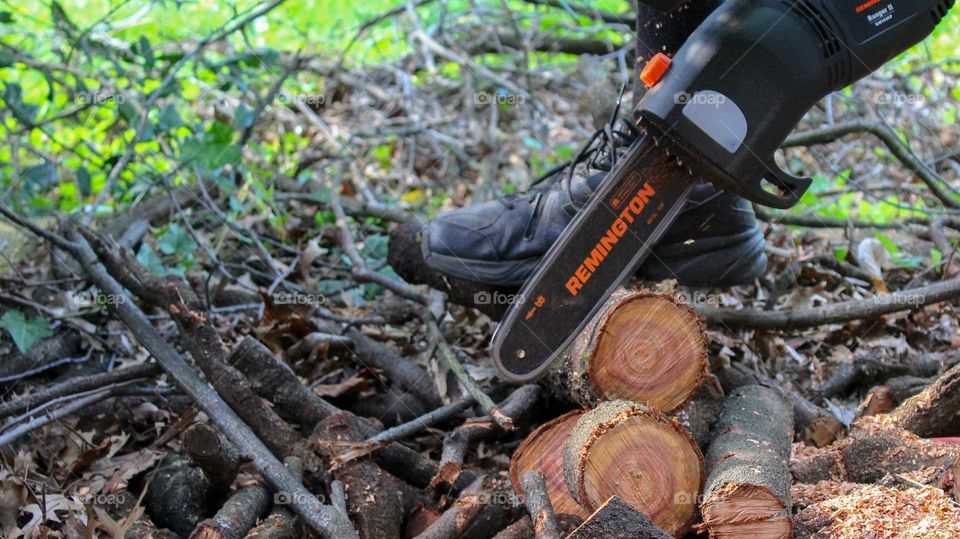 Cutting logs with a Remington electric chainsaw