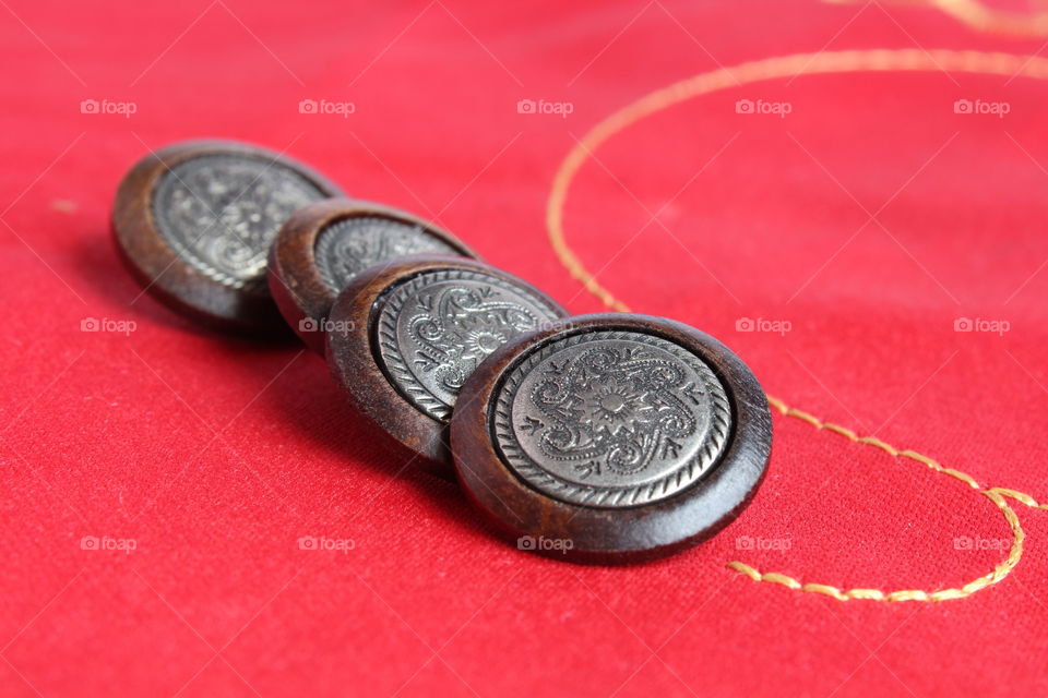 miniature clothes buttons on red background