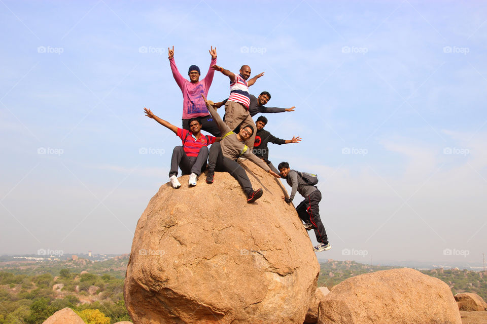 Young guys having fun on rock, rock climbing