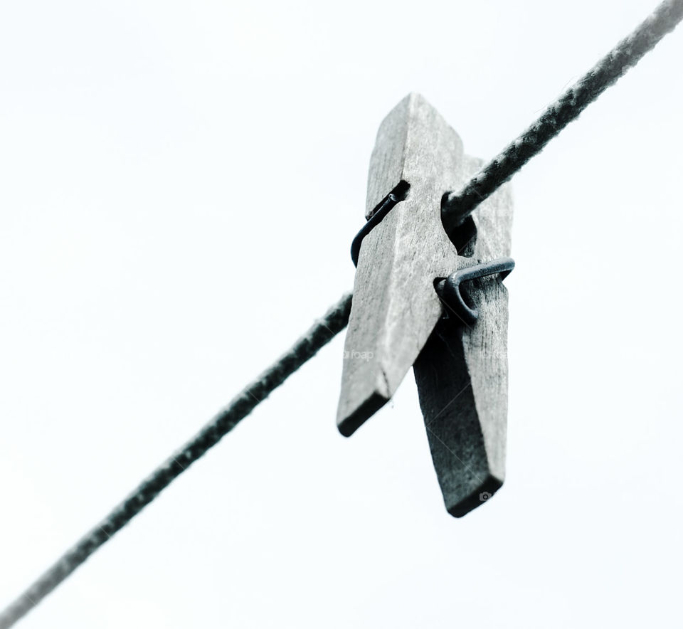 An old clothespin hanging on a rope