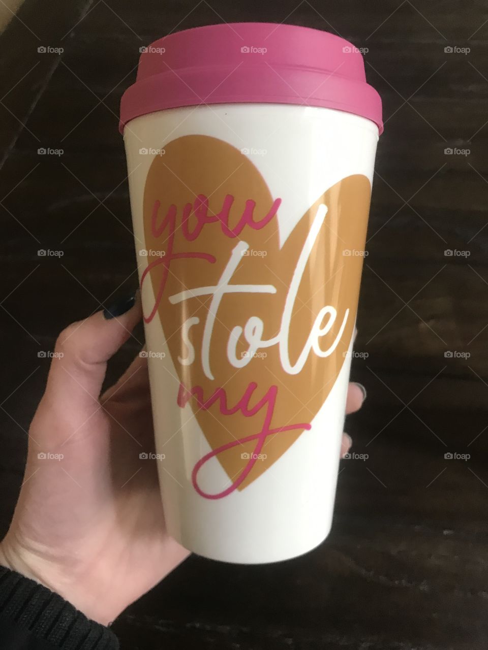 A woman holding a Valentine’s Day coffee mug with the saying you stole my heart on it. USA, America 