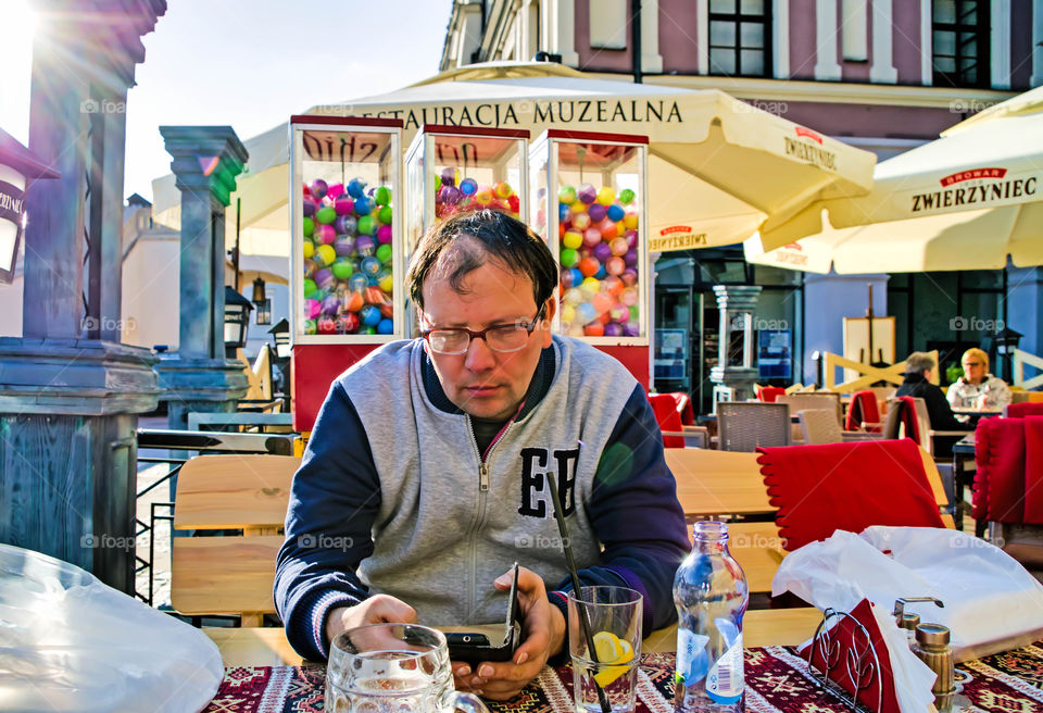 Full length of man sitting at market.