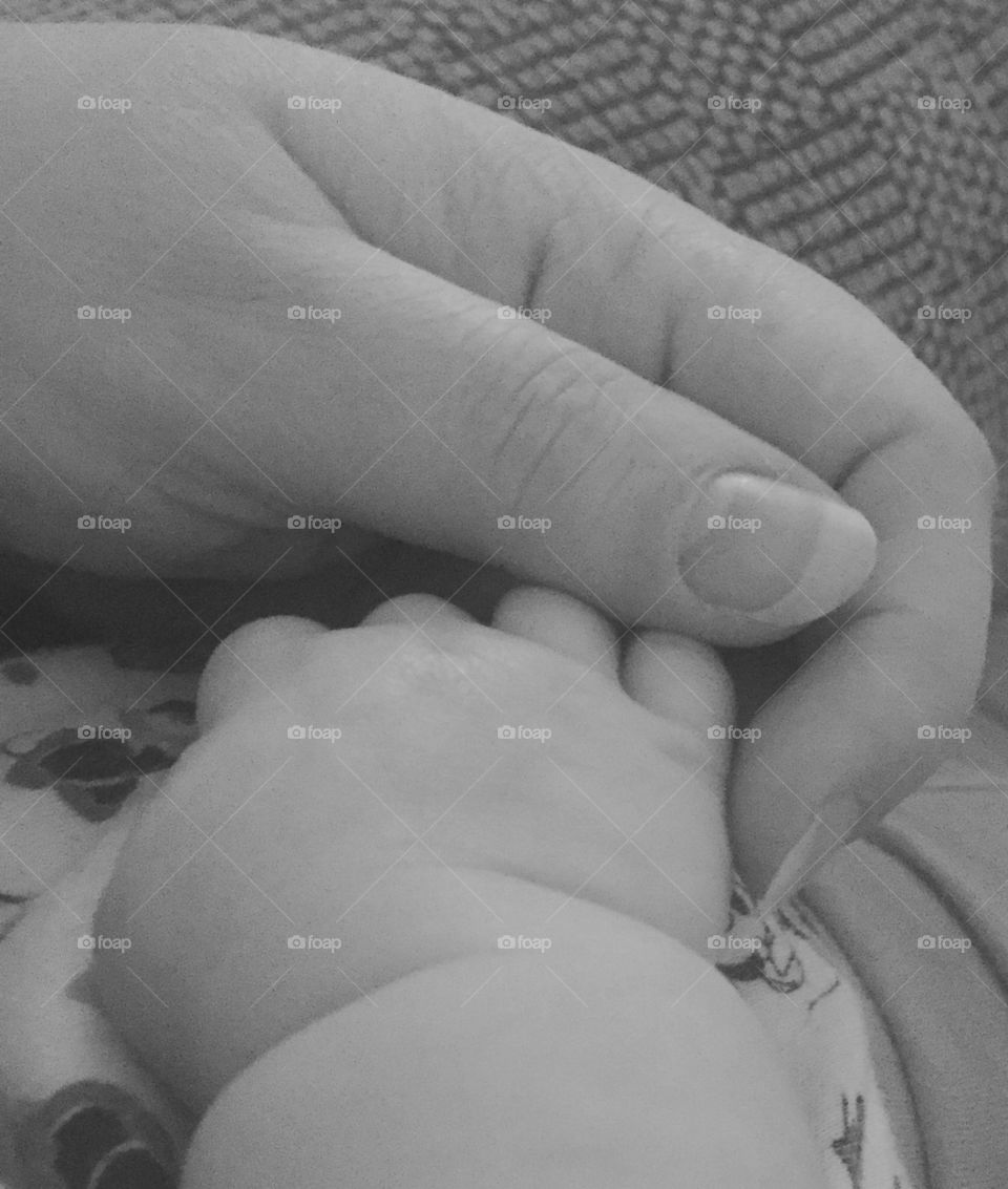 Baby hands with momma black and white 