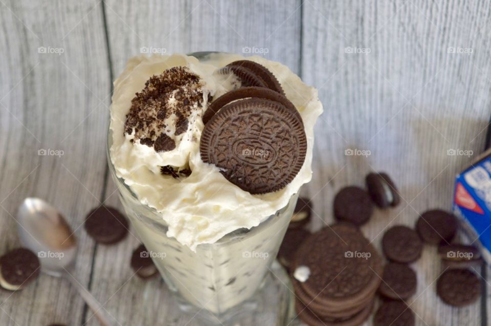 Oreo cookie milkshake with a wooden rustic white background