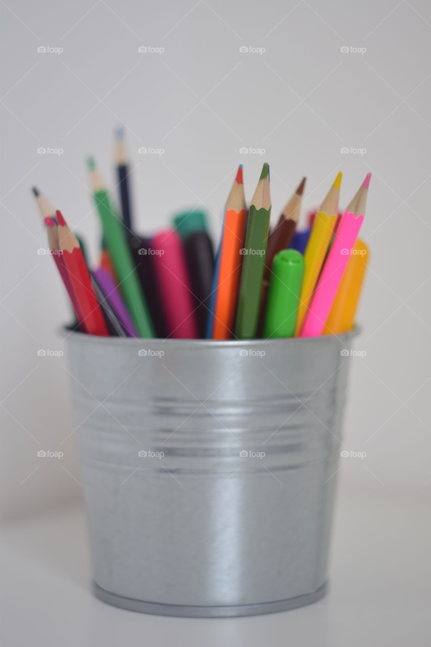 colored pencils in a bucket