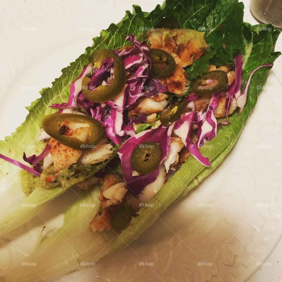 Healthy food can be fun too. Fish lettuce wraps with cabbage, guacamole, and jalapeños. Guilt free goodness.