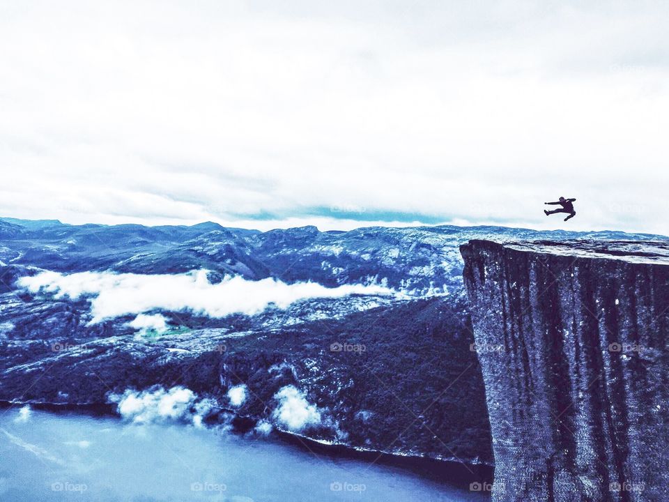 Jumping on Prekestolen rock in Norway. 