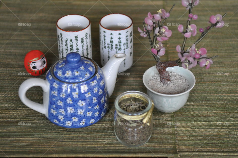 Teapot with herb on wooden table