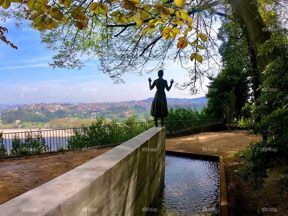 Statue in a public garden with view of Douro river, in Porto,Portugal