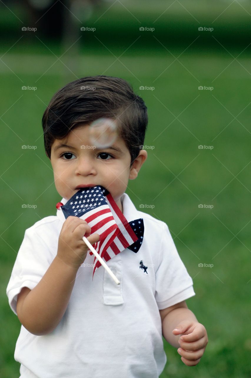 Toddler playing outdoors American flag