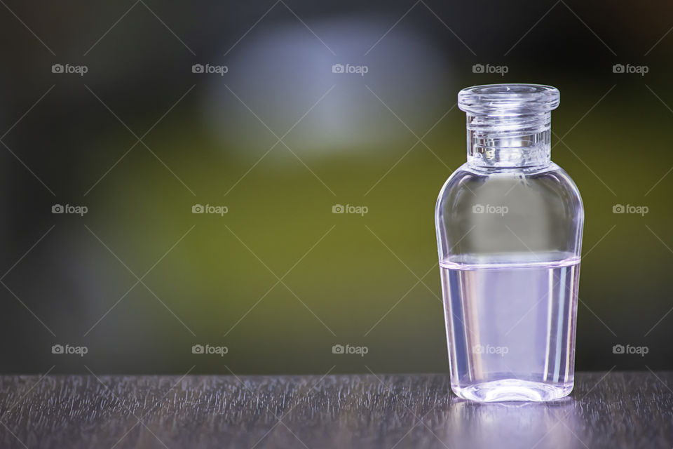 Small bottle shower gel on a wooden table The background blurry.