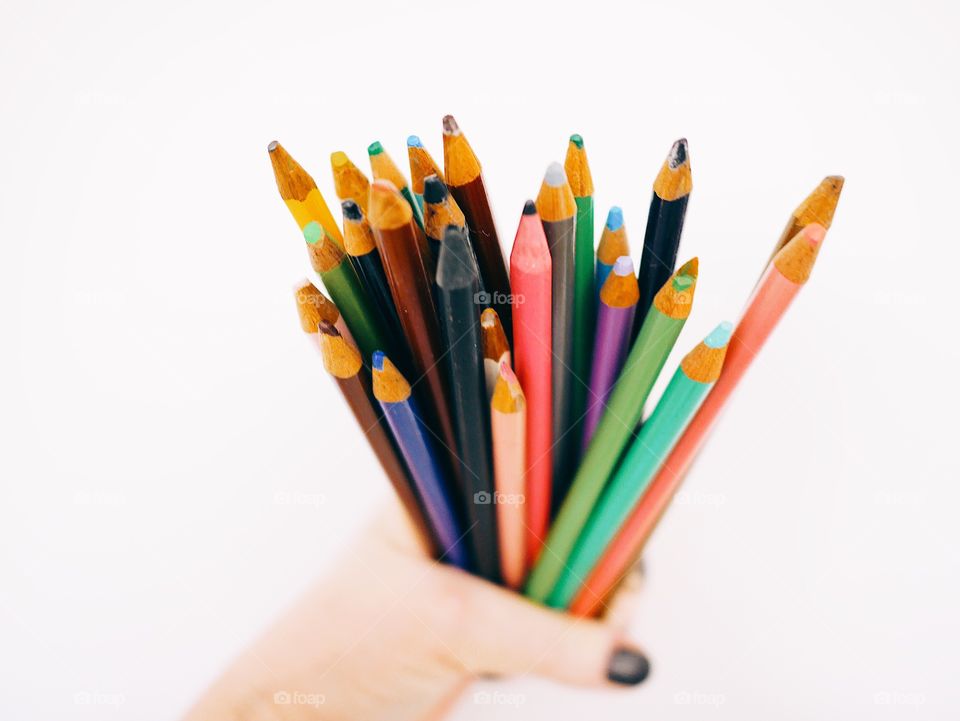 Holding colored pencils