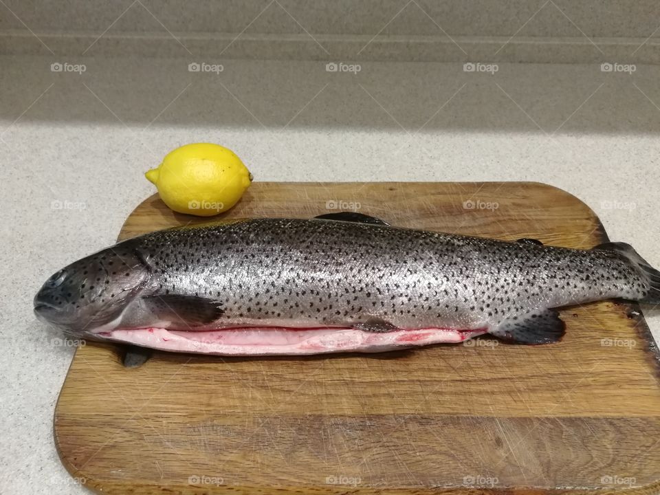 Fresh fish and lenom on the table