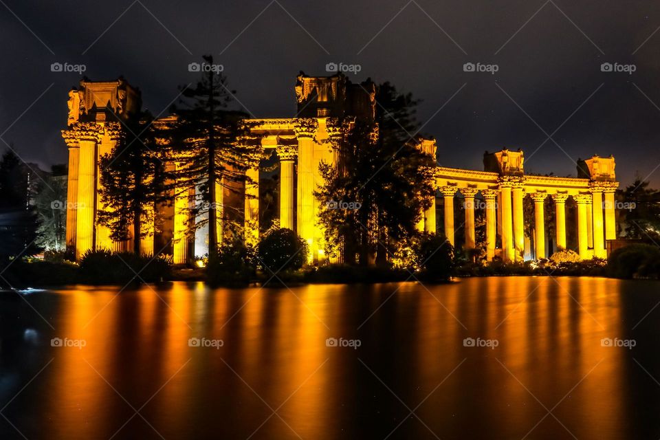 Nighttime at the Palace of Fine Arts in San Francisco California, this beautiful Beaux-Arts designed building by Bernard Maybeck for the 1915 Panama-Pacific International Exposition was meant to resemble Roman Ruins, reflecting in the lagoon