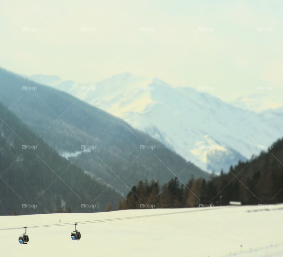 Gondolas taking skiers up a mountain in Kals, Austria.