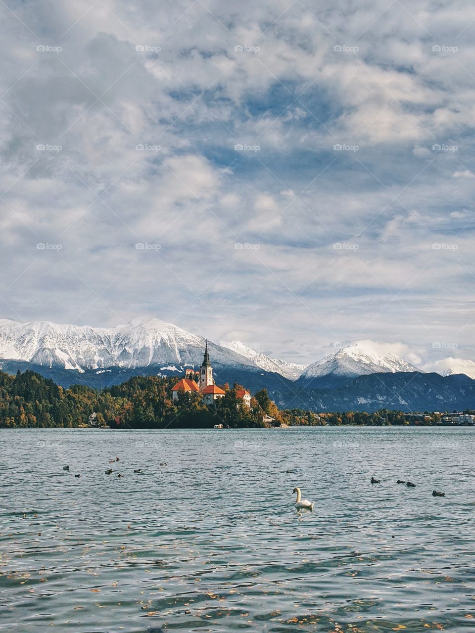 View of the snow-capped mountain peaks against the backdrop of Lake Bled.