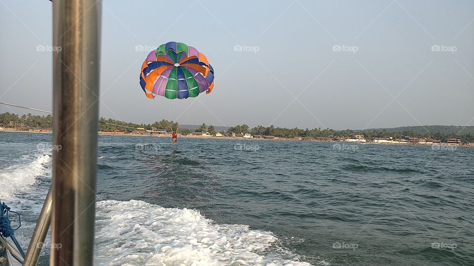 water sports . nature sea, parachute gliding, waves, awesome sunset at the time of dawn. nothing beautiful than nature. sea, waves, sunset, dawn