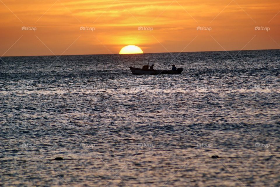 Silhouette of boat at sunset