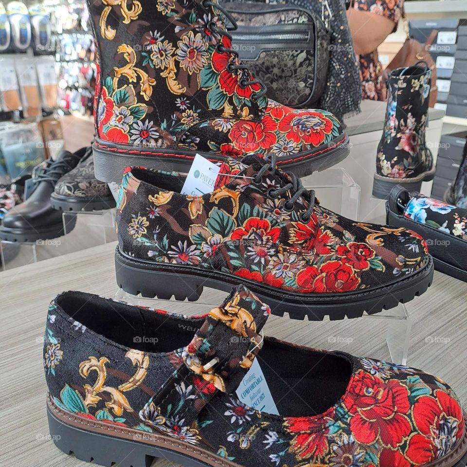 colourful footwear on display in shoe shop. patterns