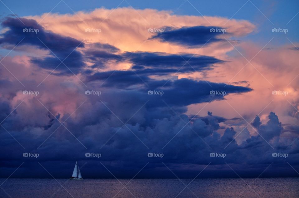 white sail boat on the dramatic sky background at the baltic sea in poland