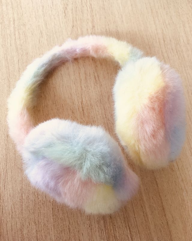 Soft fluffy earmuffs on a light and warm wooden backdrop. I love this photo, I think the combination of colour and textures is simply beautiful. Ordinary objects made extraordinary.