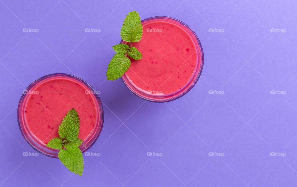 Pink smoothies on purple background 