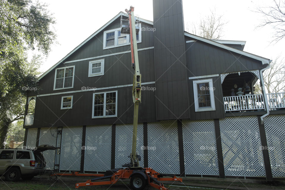 Man in a lift working in a house
