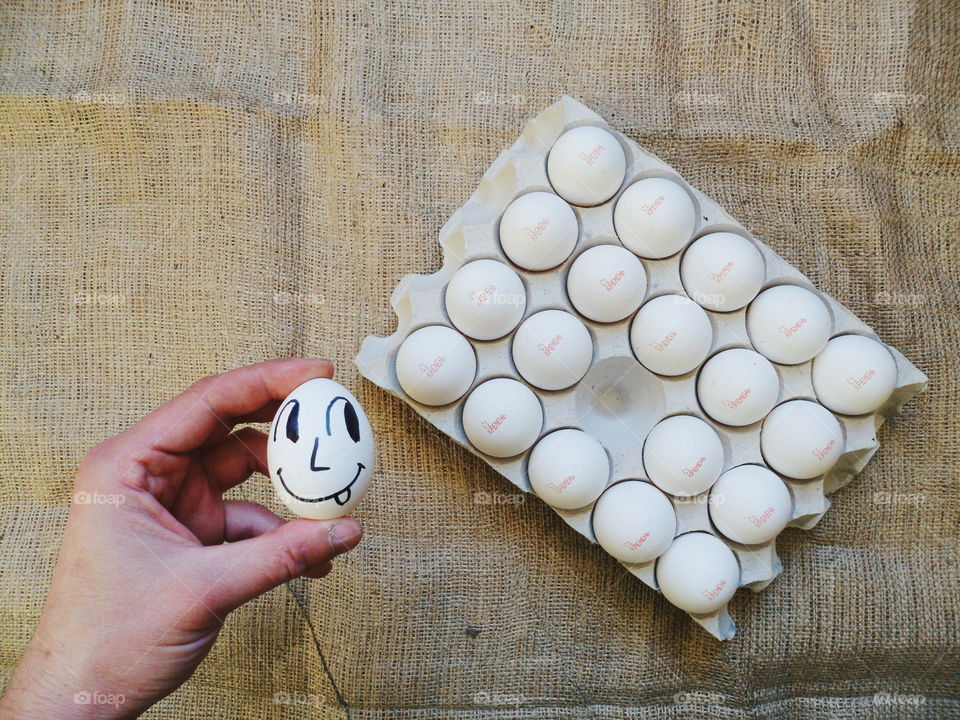 Chicken egg tray and hand holding chicken egg