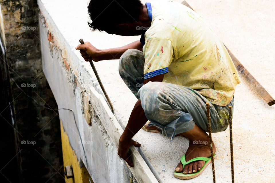 industrial worker, bricklayer, mason working on construction site with bricks and building house. masonry details