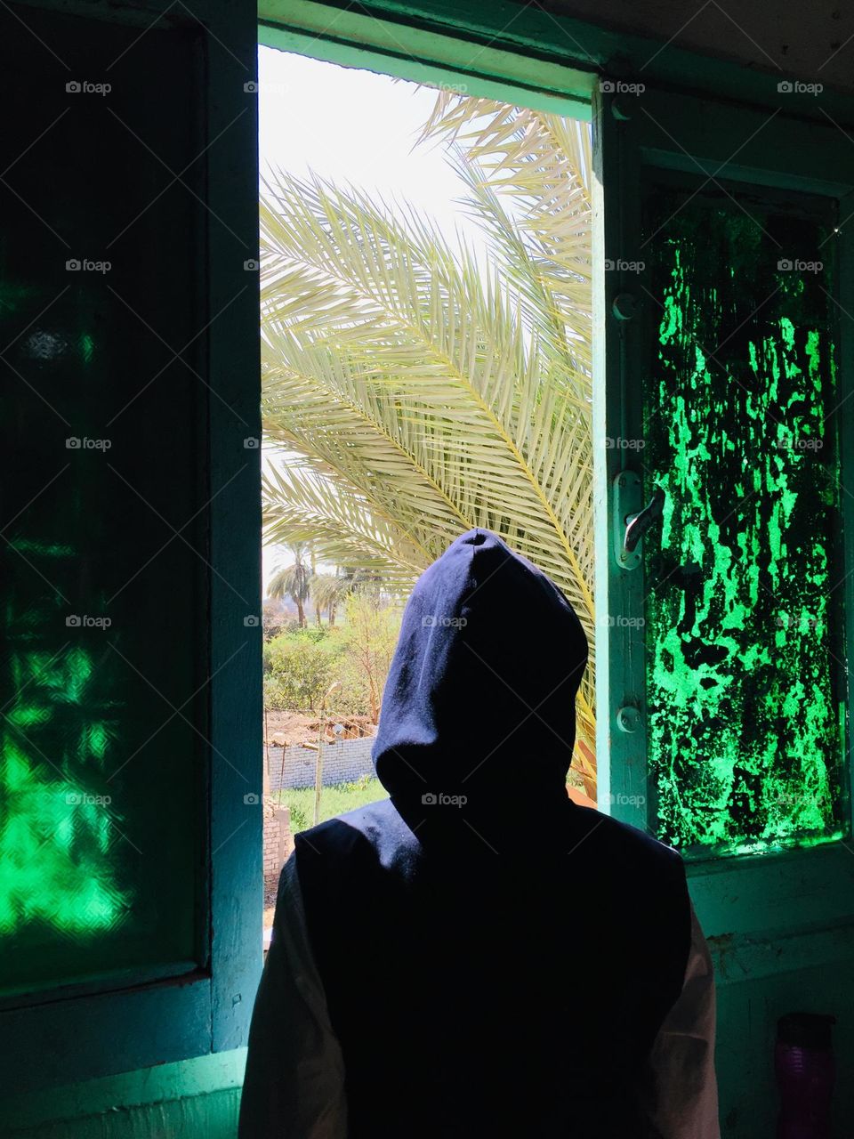 A girl is looking out of a window 