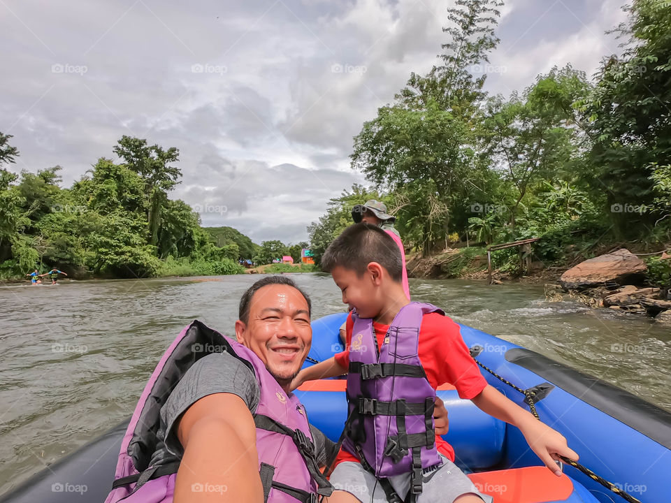 Tourists on the inflatable boat floating on the water in the river The flow of Kaeng Krachan Dam at Phetchaburi in Thailand. June 10, 2019