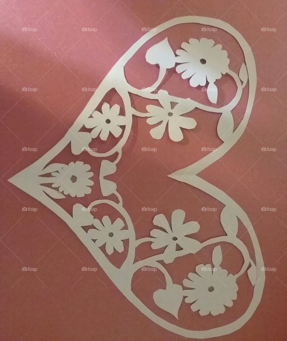 Cut paper design of heart with flowers on dusty pink mat board