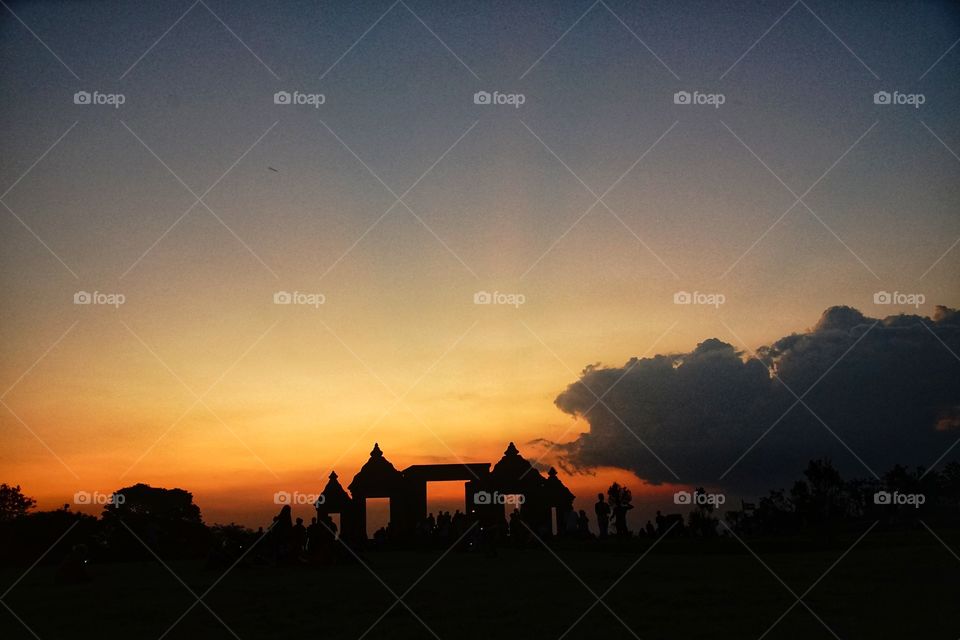 when the sun goes in, the dragon comes out. a dramatic sunset view in ratu boko archaelogical site, near Jogjakarta, Indonesia
