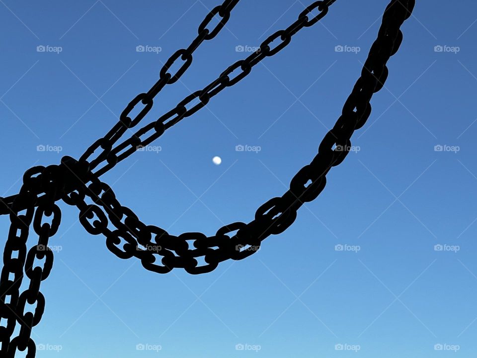 The moon framed by chains