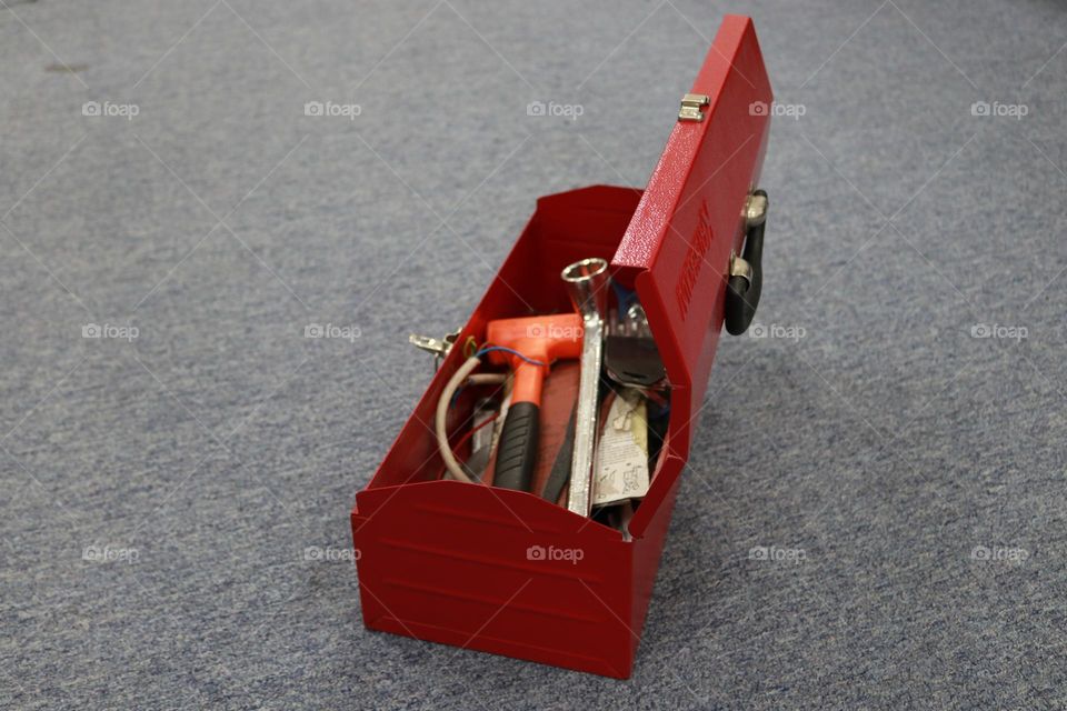 Photo of a red tool box containing tools for workers