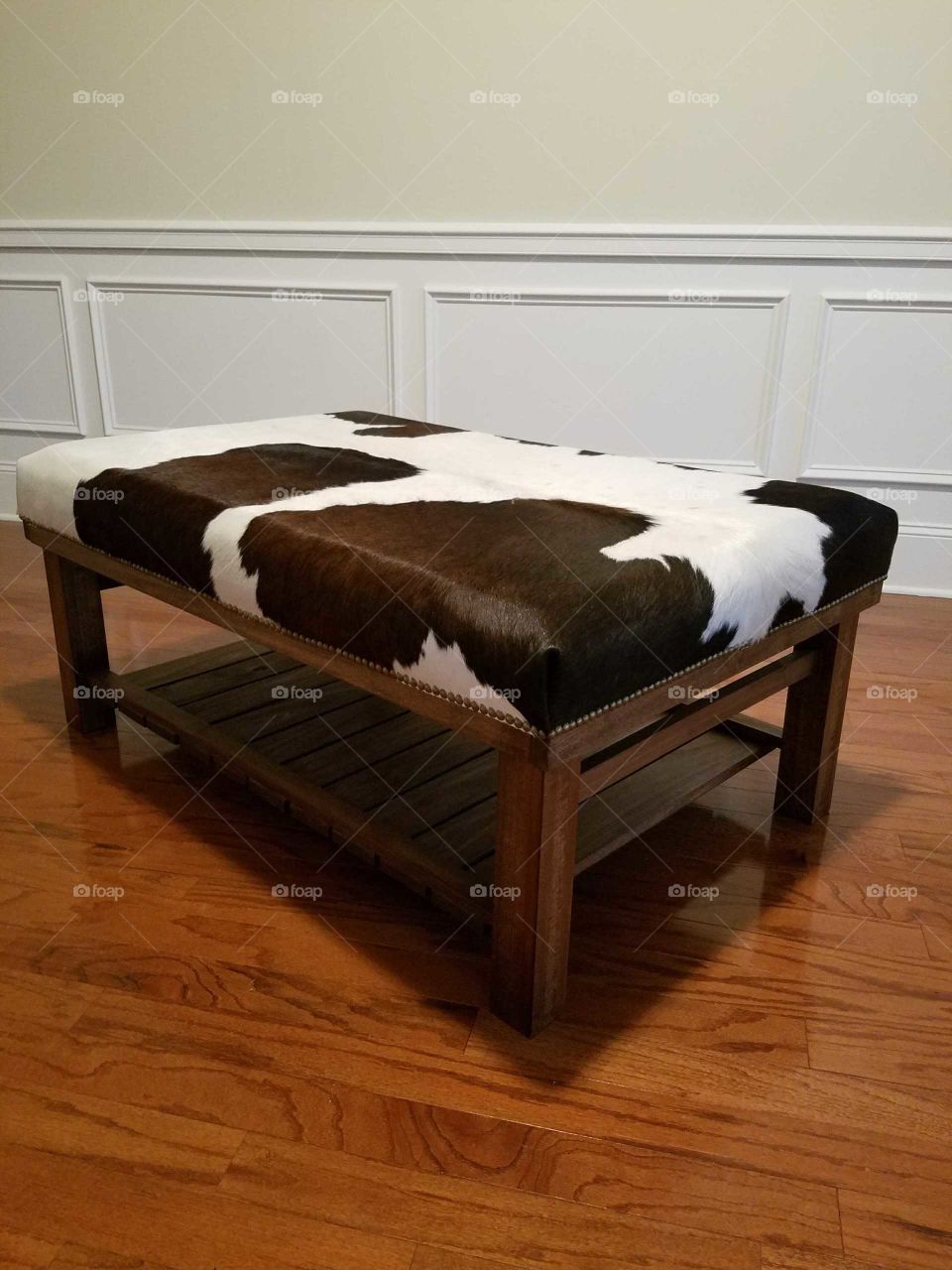 beautiful cowhide covered ottoman in brown and white, unique handmade piece of furniture