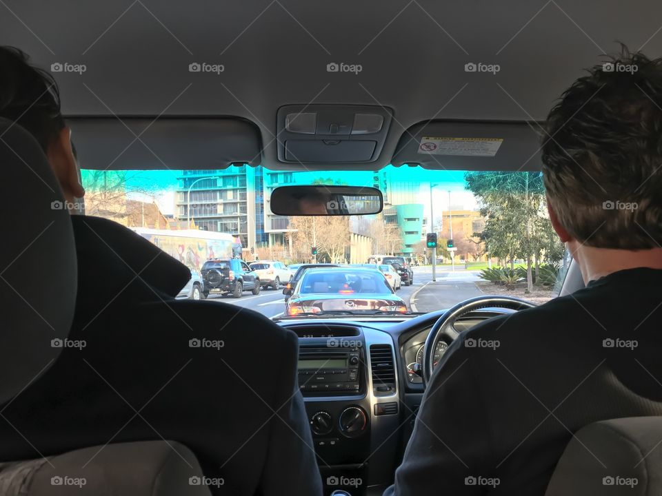 Men in front seats of SUV car right handed driving Australia 