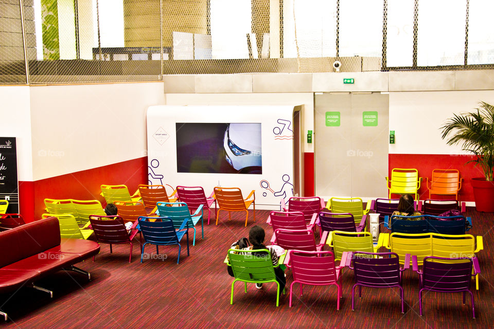 Waiting room at airport, color chairs, screen