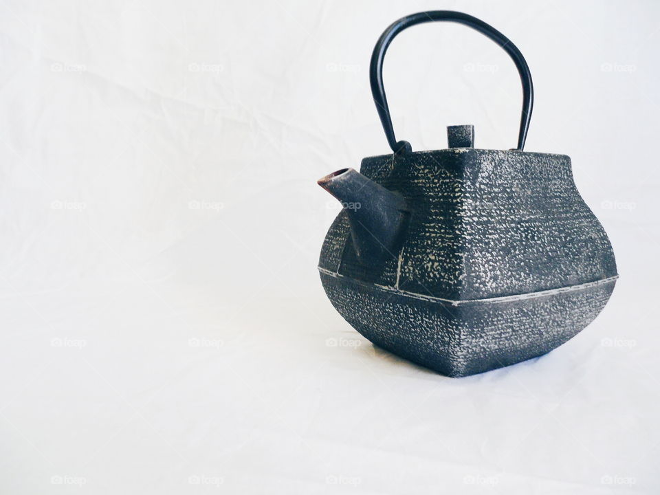 cast iron tea kettle on white background
