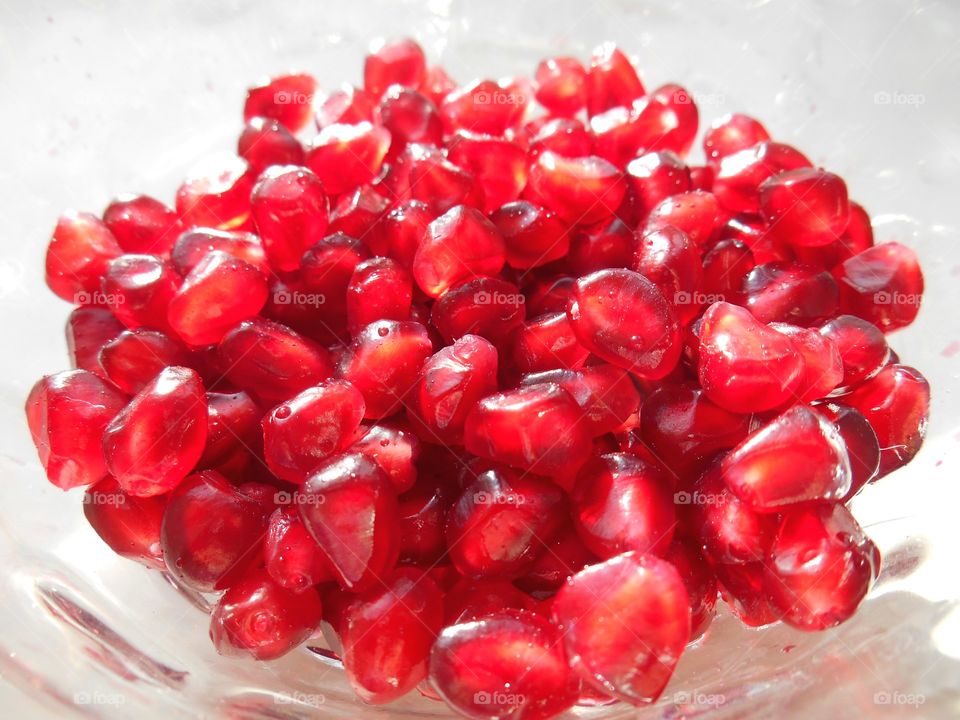 red pomegranate seeds healthy food white background