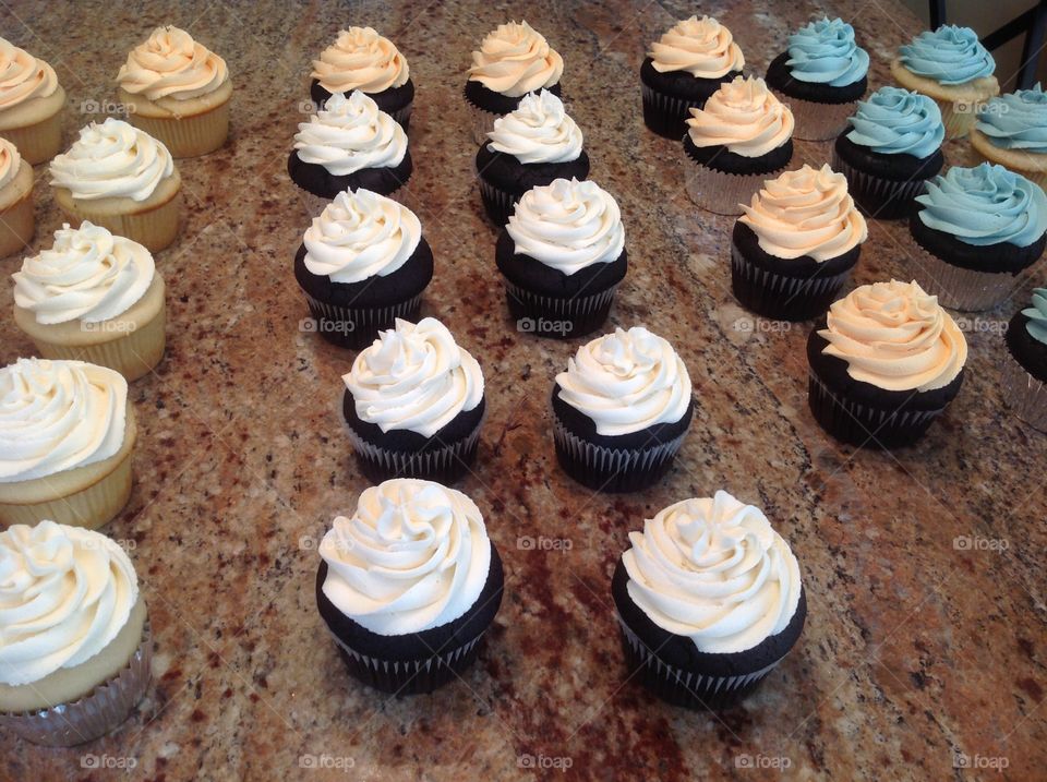 Beautiful cupcakes being prepared for bridal shower.